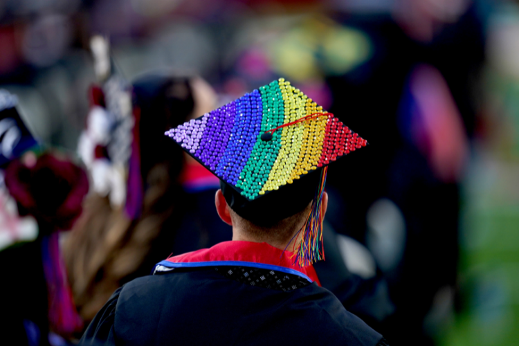 Back of graduation cap decorated in rainbow pattern beads. Click to register