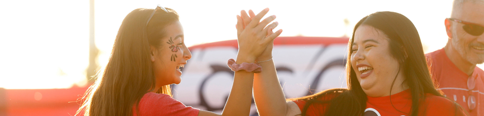 Two students giving high five to each other