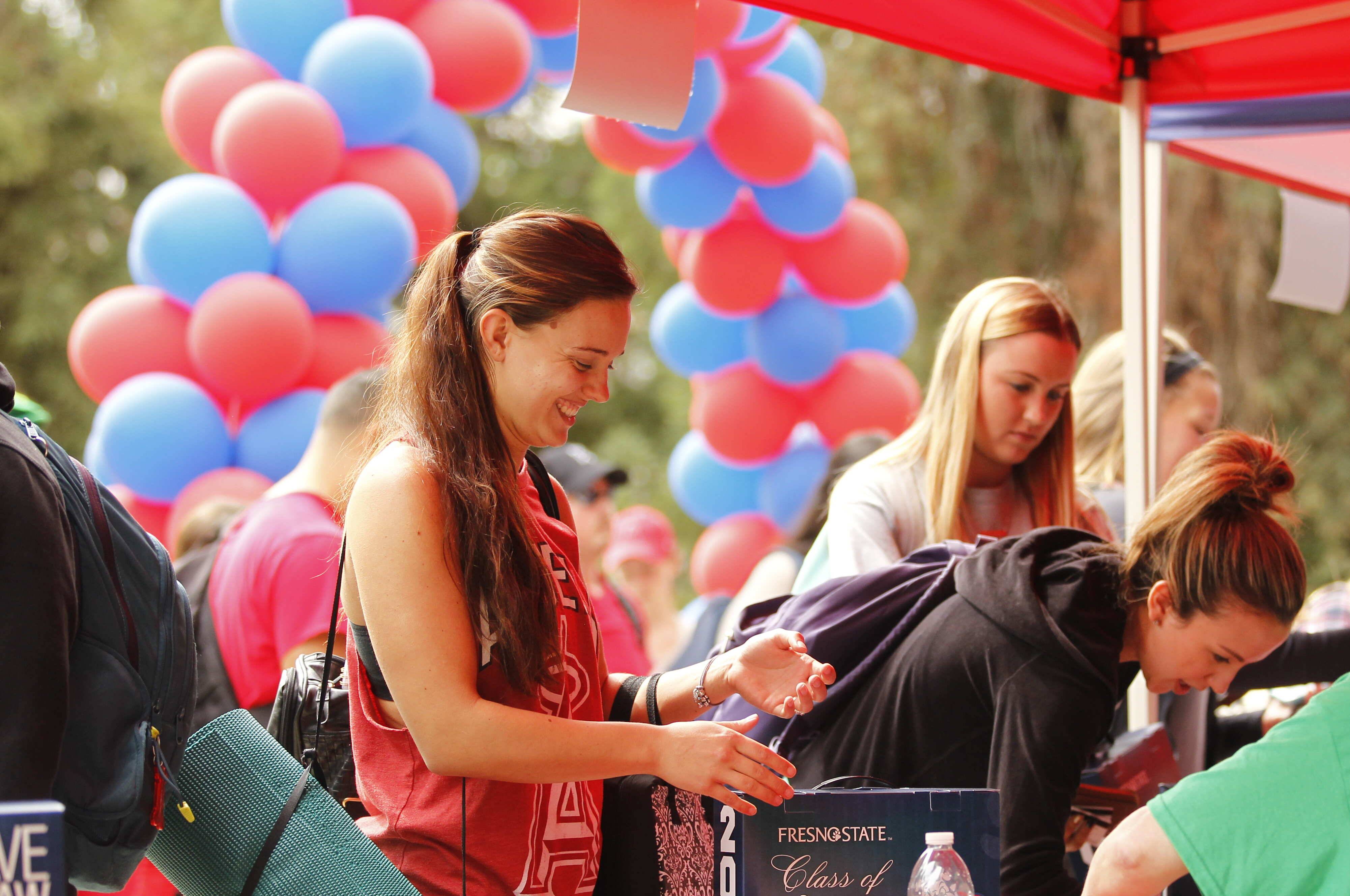 Student picking up grad box at gradfest 2015