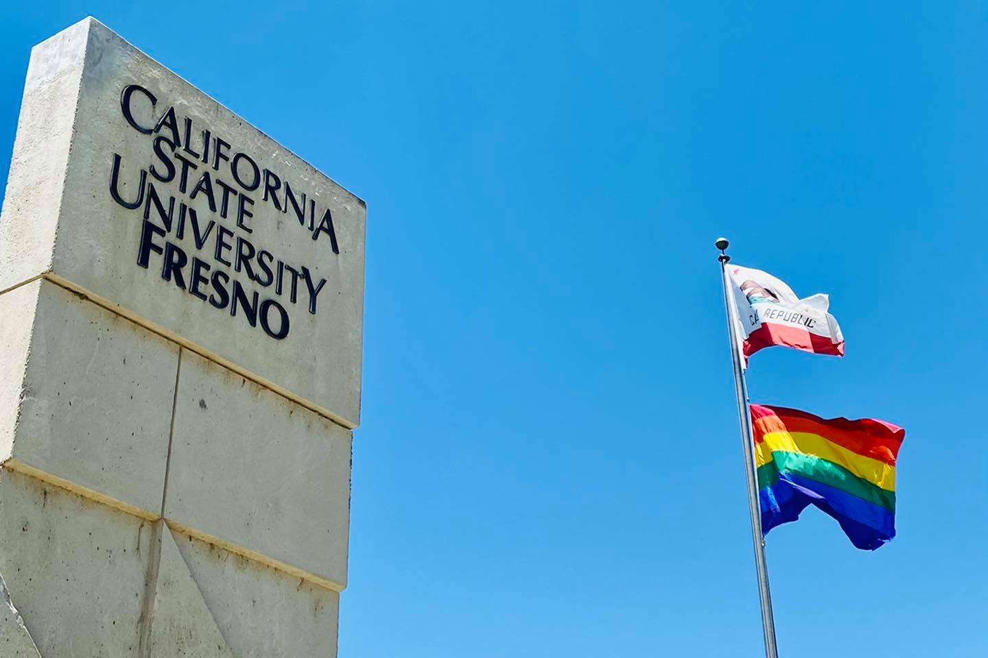 Fresno State’s inaugural rainbow pride flag raising ceremony (2021). Flag donated by Jeff Robinson. Photo by Miguel Gastelum.