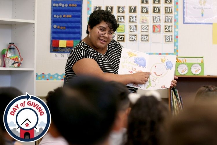 Teacher reading a book to elementary students