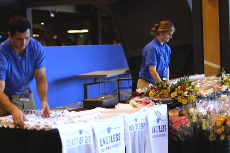 The Commencement Group staff at class T-shirt and flower table